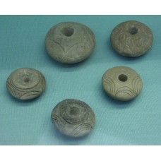 Baked clay spindle-whorls, sun disc, solar disc